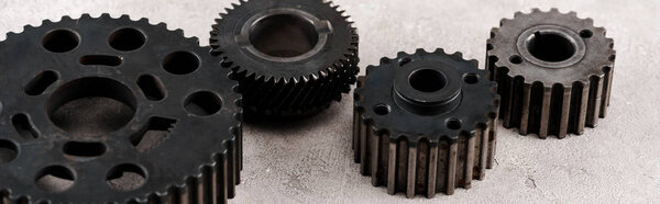 metal round gears on grey background, panoramic shot