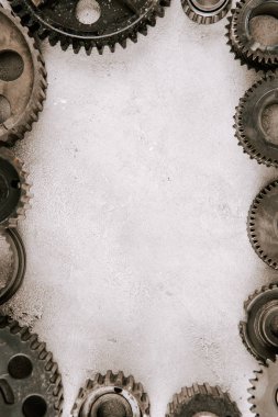 frame of aged metal round gears on grey background with copy space clipart