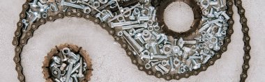top view of aged metal gears and screws arranged in taijitu symbol on grey background, panoramic shot clipart