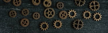 top view of vintage metal gears on dark wooden background, panoramic shot clipart