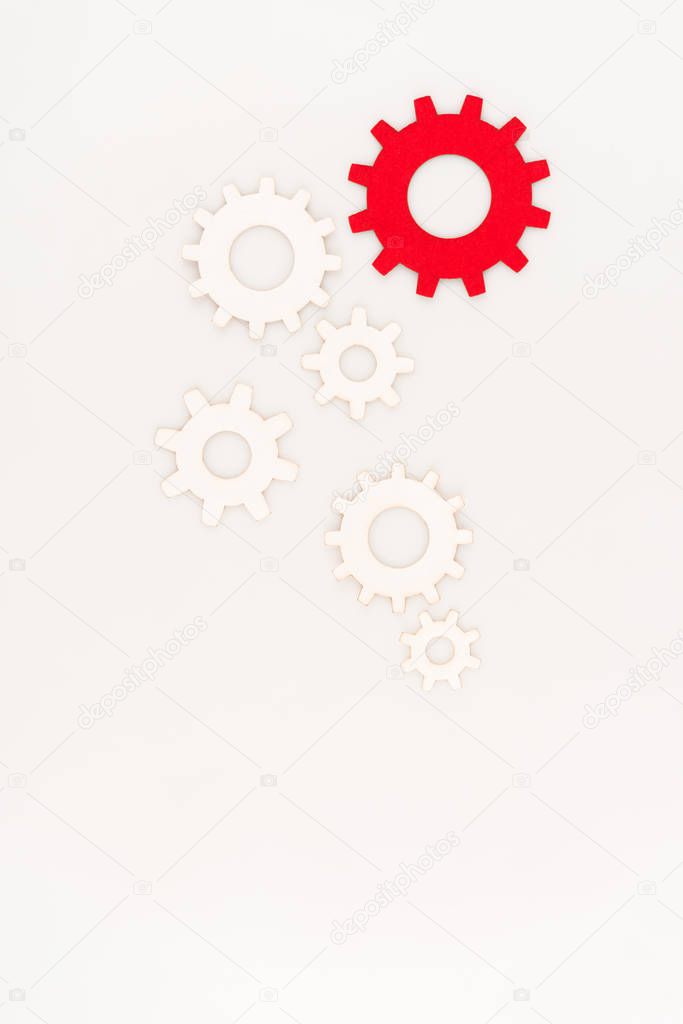 top view of one red gear among another isolated on white