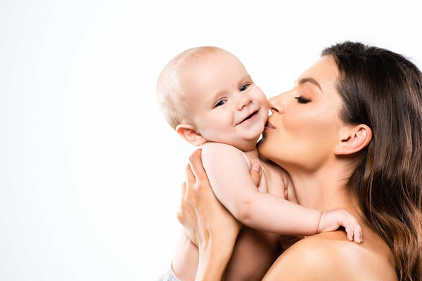 portrait of naked mother kissing cute baby, isolated on white