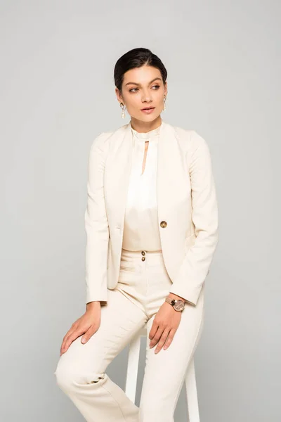 Elegant Businesswoman White Suit Sitting Stool Isolated Grey — Stock Photo, Image