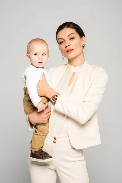 Bela Mulher Negócios Com Bebê Adorável Mãos Isolado Cinza — Fotografia de Stock