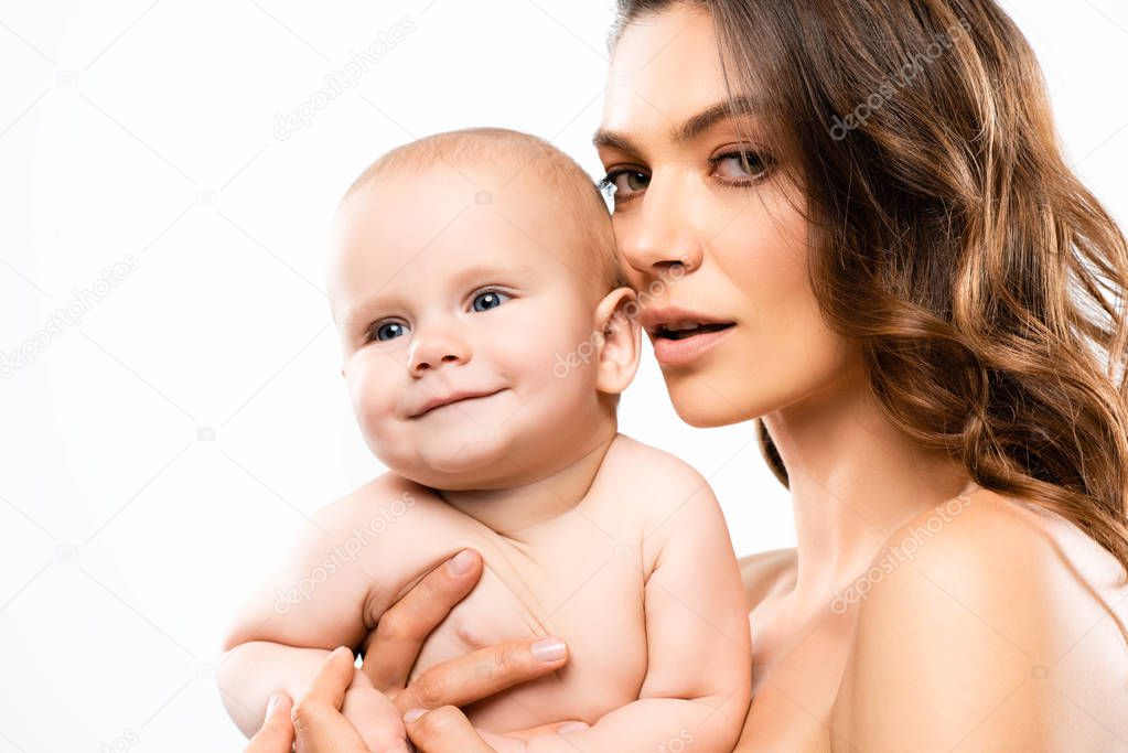 portrait of attractive nude mother holding baby, isolated on white