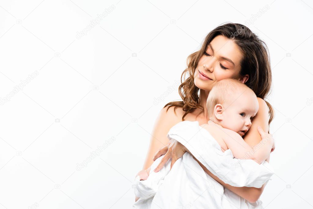 portrait of nude mother with closed eyes holding baby, isolated on white