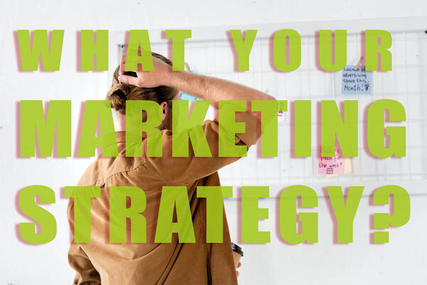 back view of man in shirt looking at white board in office with what your marketing strategy illustration
