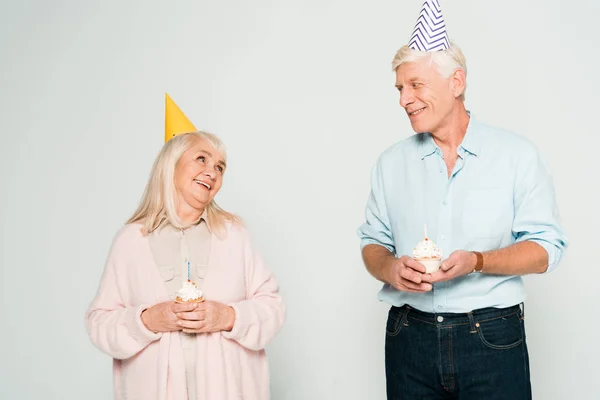 Happy Senior Husband Wife Holding Birthday Cupcakes Looking Each Other — Stock Photo, Image