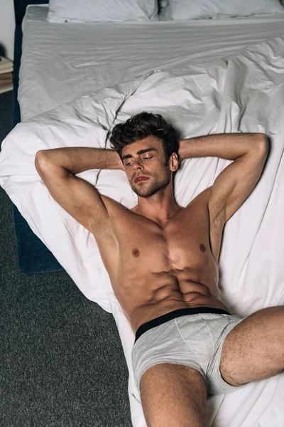 Sexy Shirtless Man Looking Away While Lying Floor Bed — Stock Photo, Image