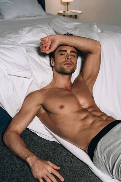 Sexy Thoughtful Man Looking Camera While Lying Floor Bed — Stock Photo, Image