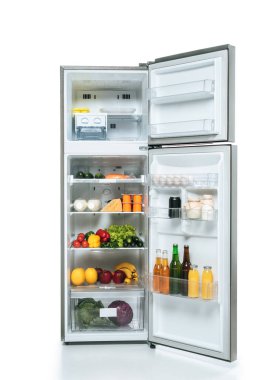 open fridge and freezer with fresh food on shelves isolated on white clipart