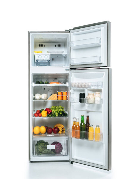 open fridge and freezer with fresh food on shelves isolated on white