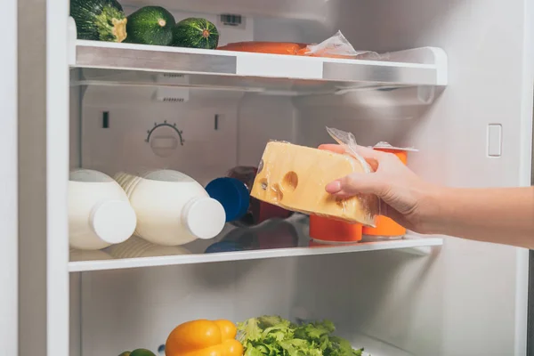 Cropped View Woman Holding Cheese Open Fridge Fresh Food Shelves — Stock Photo, Image