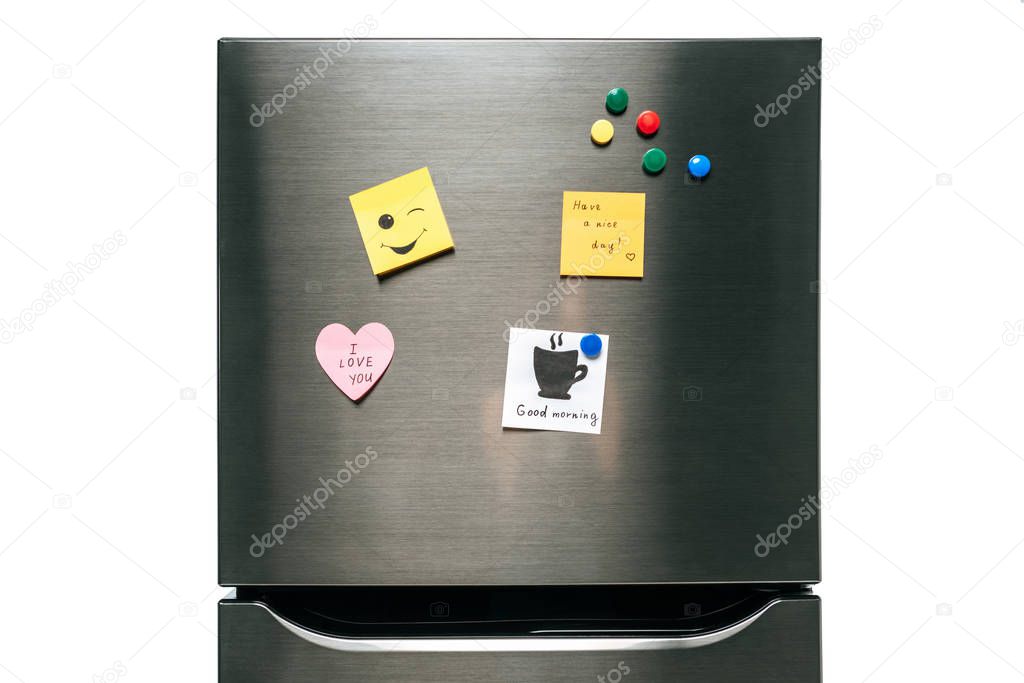 notes with wishes and magnets hanging on fridge isolated on white