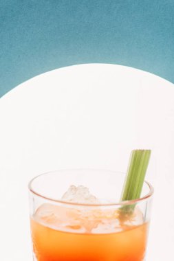 close up view of bloody Mary with celery on blue background with back light clipart