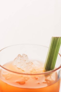 close up view of bloody Mary with celery and ice isolated on white clipart