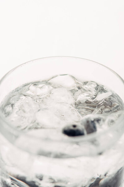 close up view of fresh gin and tonic in glass isolated on white