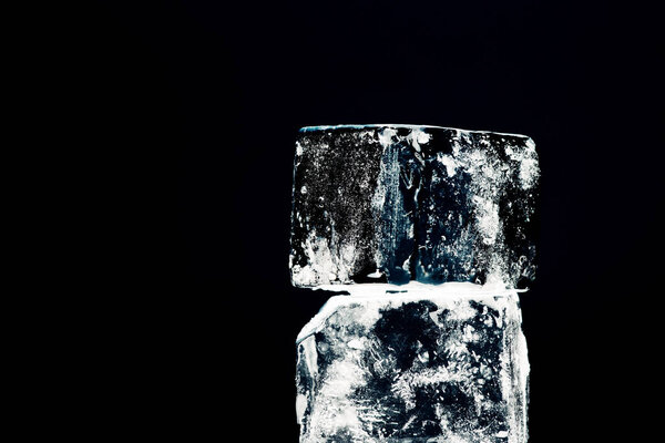 close up view of square ice cubes isolated on black