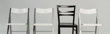 Black and white chairs isolated on grey, panoramic shot clipart