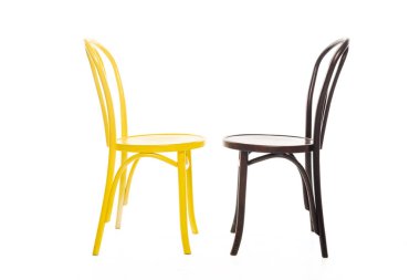 Yellow and brown wooden chairs isolated on white clipart