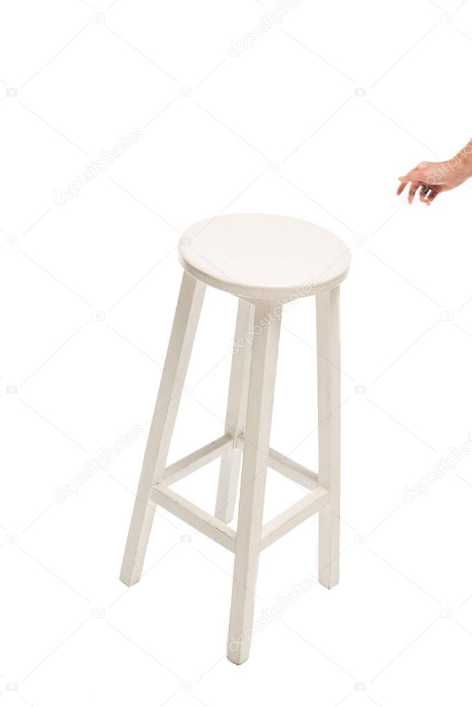Cropped view of man pulling hand to white stool isolated on white 