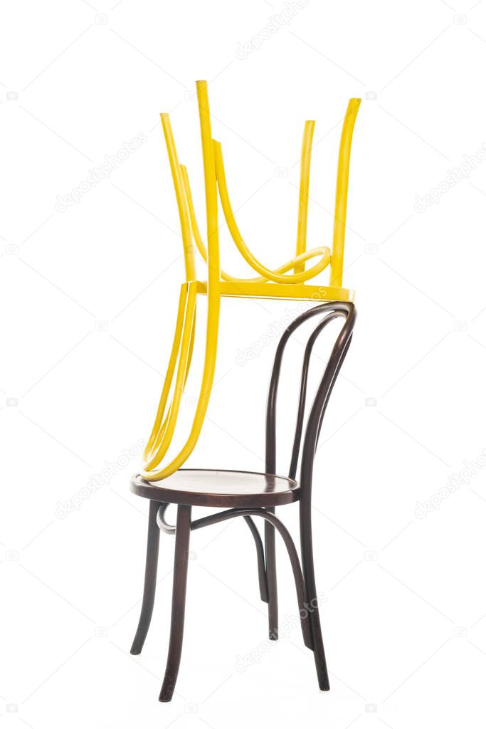 Yellow and brown wooden chairs isolated on white