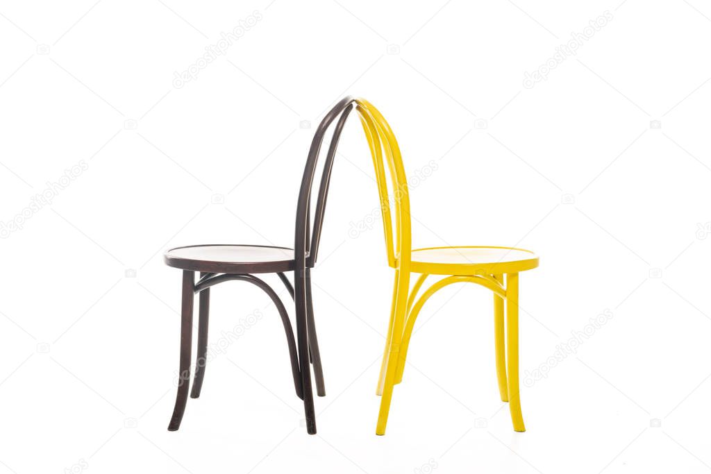 Yellow and brown wooden chairs isolated on white