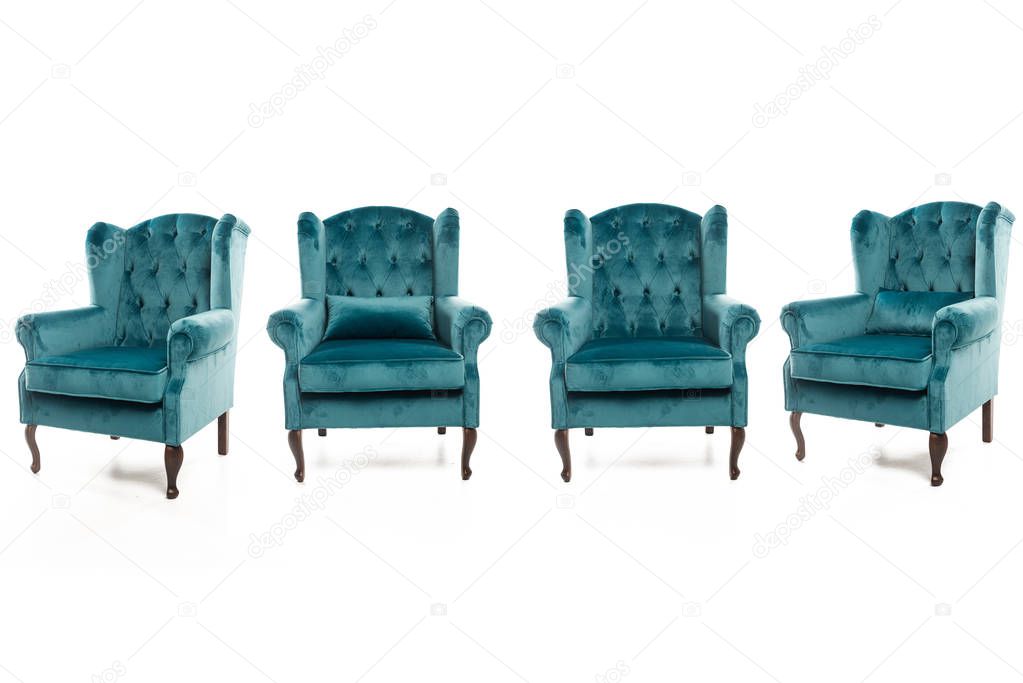 Trendy turquoise armchairs on white background