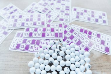selective focus of balls with numbers in glass near lottery tickers  clipart