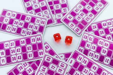 top view of red dice near lottery tickets isolated on white  clipart