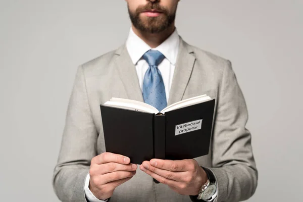 Cropped View Businessman Reading Book Intellectual Property Title Isolated Grey — Stock Photo, Image