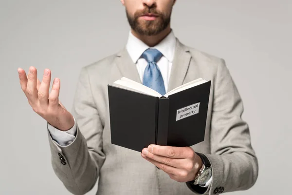Cropped View Businessman Reading Book Intellectual Property Title Isolated Grey — Stock Photo, Image
