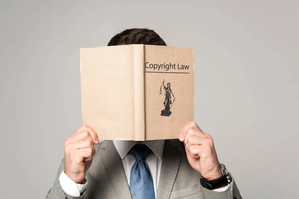 Адвокат Затемнює Обличчя Книгою Про Авторське Право Ізольовано Сірому — стокове фото