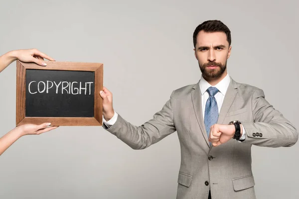Cropped View Woman Holding Chalkboard Copyright Inscription Businessman Looking Camera — Stock Photo, Image