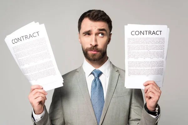 Skeptical Businessman Holding Contracts Looking Away Isolated Grey — Stock Photo, Image