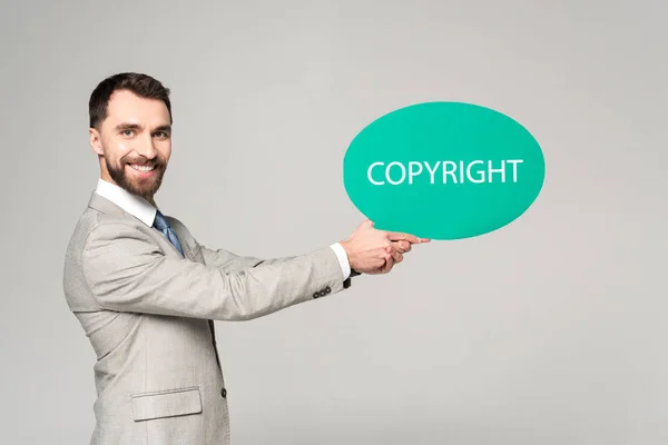 Handsome Businessman Holding Speech Bubble Word Copyright Smiling Camera Isolated — Stock Photo, Image