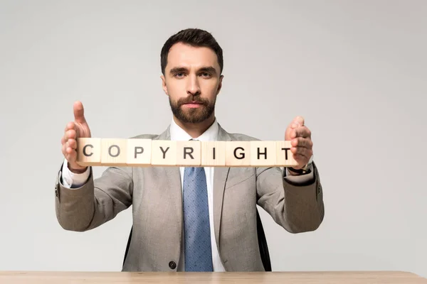 Confident Businessman Holding Wooden Cubes Copyright Lettering Isolated Grey — Stock Photo, Image