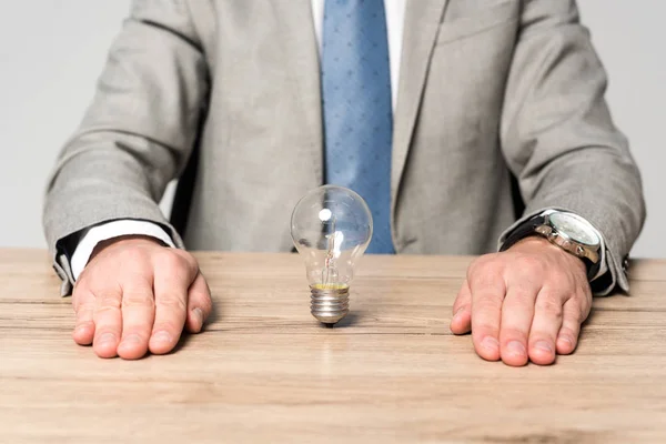 Partial View Businessman Sitting Desk Light Bulb Isolated Grey — Stock Photo, Image