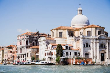 VENICE, ITALY - SEPTEMBER 24, 2019: canal with vaporettos near Santa Maria della Salute in Venice, Italy  clipart