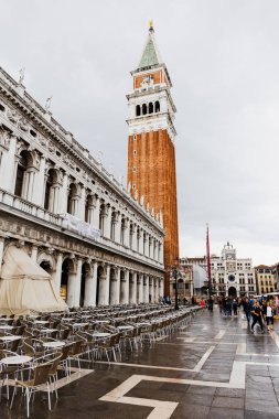 VENICE, ITALY - SEPTEMBER 24, 2019: people walking near saint mark bell tower in Venice, Italy  clipart