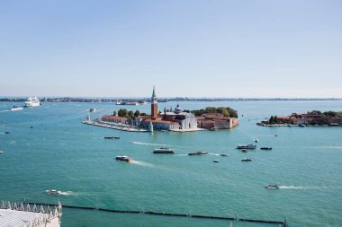 San Giorgio Maggiore island and motor boats floating on river in Venice, Italy  clipart