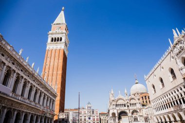 low angle view of Saint Mark Bell Tower and Cathedral Basilica of Saint Mark in Venice, Italy  clipart