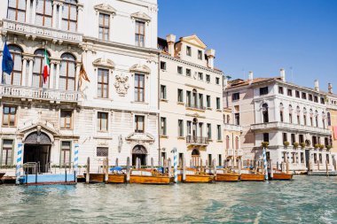 river with motor boats near ancient buildings in Venice, Italy  clipart