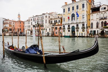 canal with gondola and ancient buildings in Venice, Italy  clipart