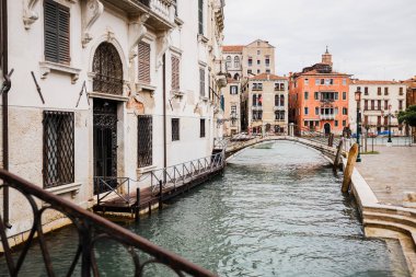  bridge above canal near ancient buildings in Venice, Italy  clipart