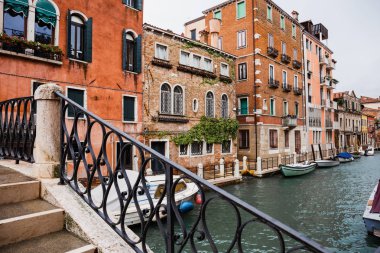 canal, motor boats and ancient buildings in Venice, Italy  clipart