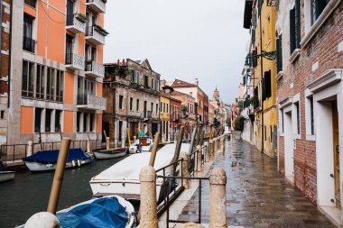 canal, motor boats and ancient buildings in Venice, Italy  clipart