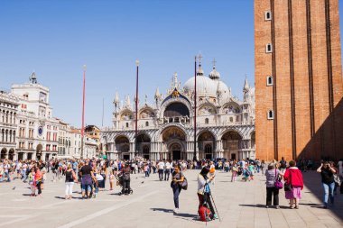 Venedik, İtalya - 24 Eylül 2019: Venedik, İtalya 'da Aziz Mark Bazilikası ve saat kulesi yakınlarında yürüyen turistler 