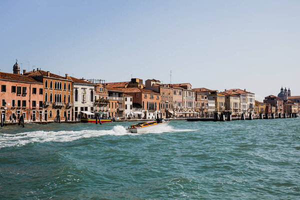 VENICE, ITALY - SEPTEMBER 24, 2019: motor boat floating on grand canal in Venice, Italy 