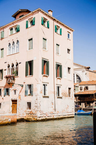 view of ancient building near canal in Venice, Italy 